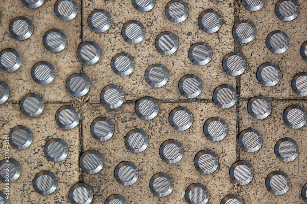Closeup view of metal floor studs that help the visually impaired. Closeup view of metal floor studs that help the visually impaired.