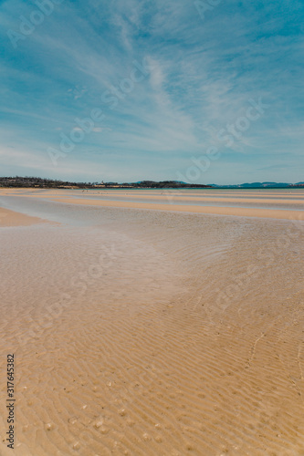 view of Dunalley Beach in Tasmania, Australia with sandbanks and shallow pristine water