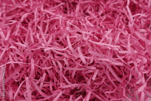 Close up of pink paper strips from shredder full frame for background and texture.