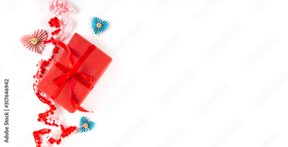 Red gift box with heart and bow on white background. Valentines day 14 february packaging concept. Flat lay, copy space, top view. Wide banner.