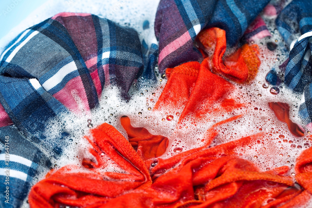 Hand washing clothes, soaking clothes in washing powder, household chores Stock Photo Adobe Stock