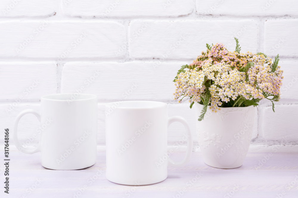 Two coffee mug mockup with pink beige wild flowers Two coffee mug mockup with pink beige wild flowers
