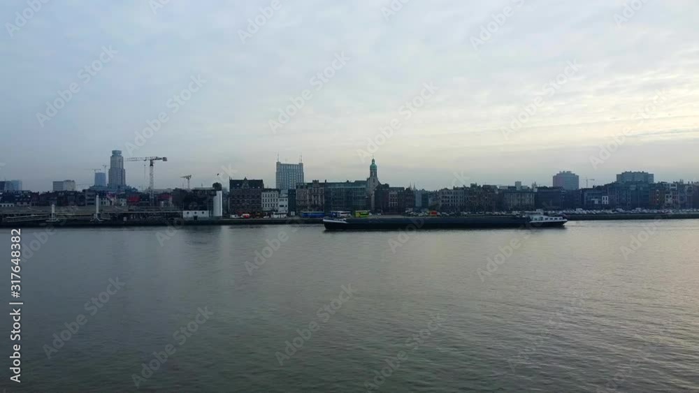 International vessel riding on scheldt river on the way to container harbor,beside antwerp city International vessel riding on scheldt river on the way to container harbor,beside antwerp city