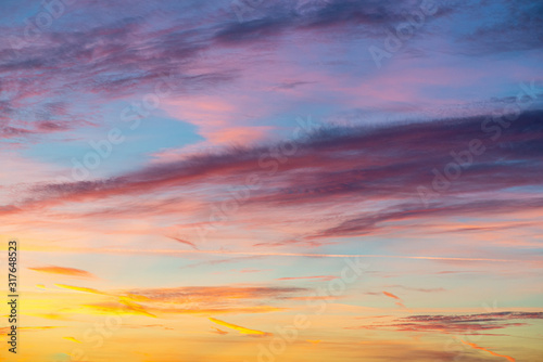 Fototapeta Naklejka Na Ścianę i Meble -  Evening sunset sky with bright rays of the sun and beautiful colorful clouds