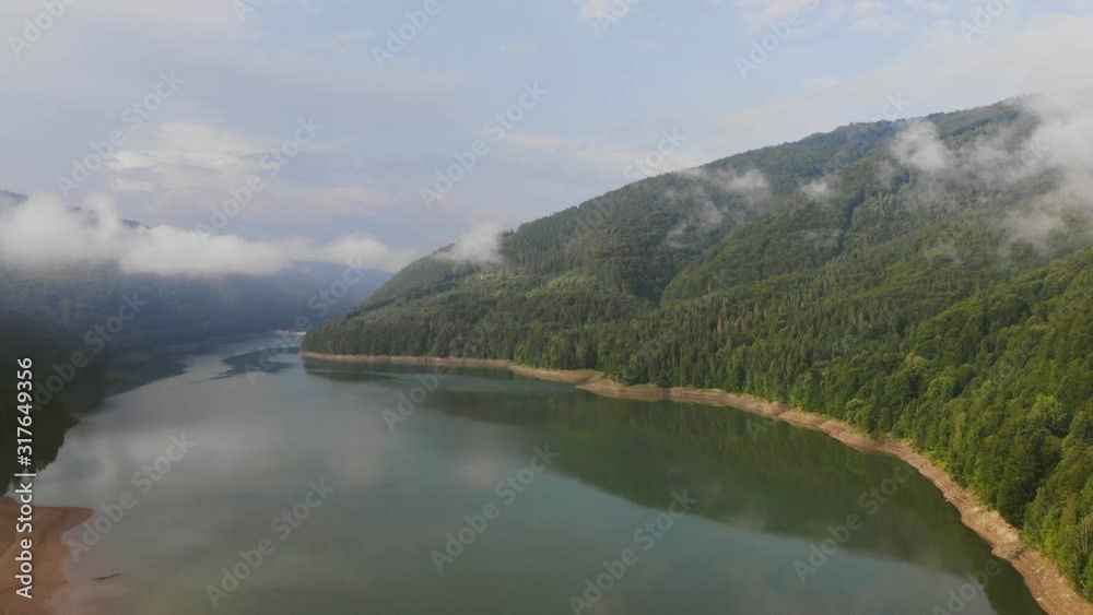 Sea bay surrounded by green mountains. Video shot with a drone. It can also be interpreted as a mountain lake or a fjord. Sea bay surrounded by green mountains. Video shot with a drone. It can also be interpreted as a mountain lake or a fjord.