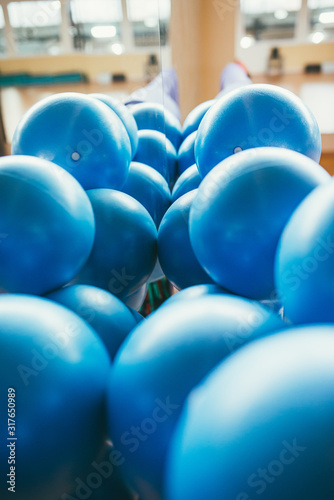 big blue rubber balls in the gym near the mirror. Selective focus macro shot with shallow DOF