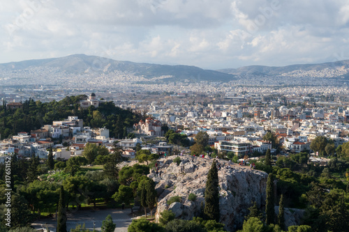 Athens, Greece - Dec 20, 2019: View from the Acropolis of the Athens skyline and the Areopagus (Ares Rock), under a hazy sky caused by dust clouds