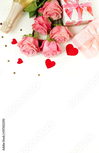 Valentine's day background. Bouquet of pink roses flowers, gift box and champ...
