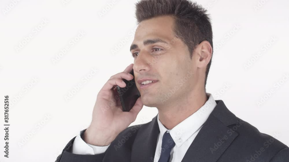 Close up portrait of handsome mixed-race man wearing suit talking on telephone on white background Close up portrait of handsome mixed-race man wearing suit talking on telephone on white background