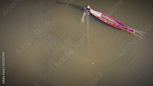 Aerial image, Fishing boat fishing in the lake in sunset time.