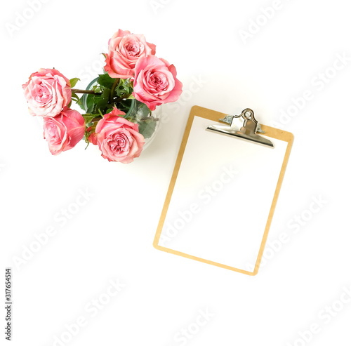 Beautiful pink roses bouquet in a  vase and blank mock up isolated on white b...