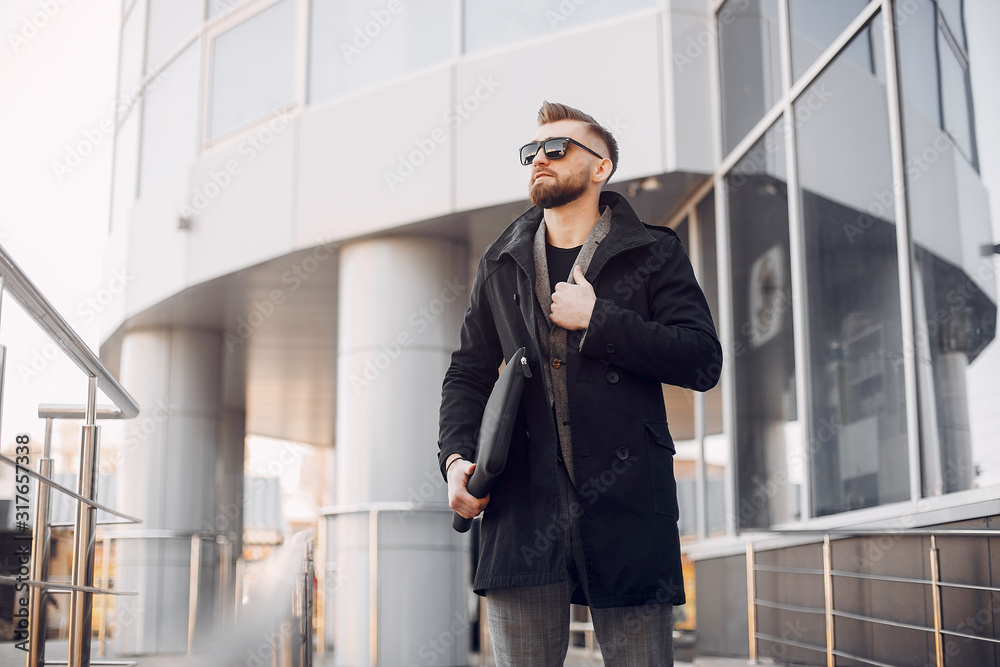 Man in a stylish suit. Businessman in a summer city Man in a stylish suit. Businessman in a summer city