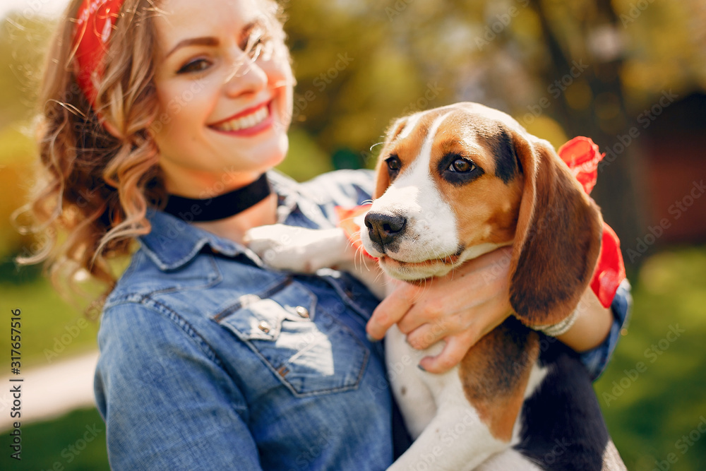Beautiful girl in a blue blouse. Woman in a summer park. Lady with a dog Beautiful girl in a blue blouse. Woman in a summer park. Lady with a dog