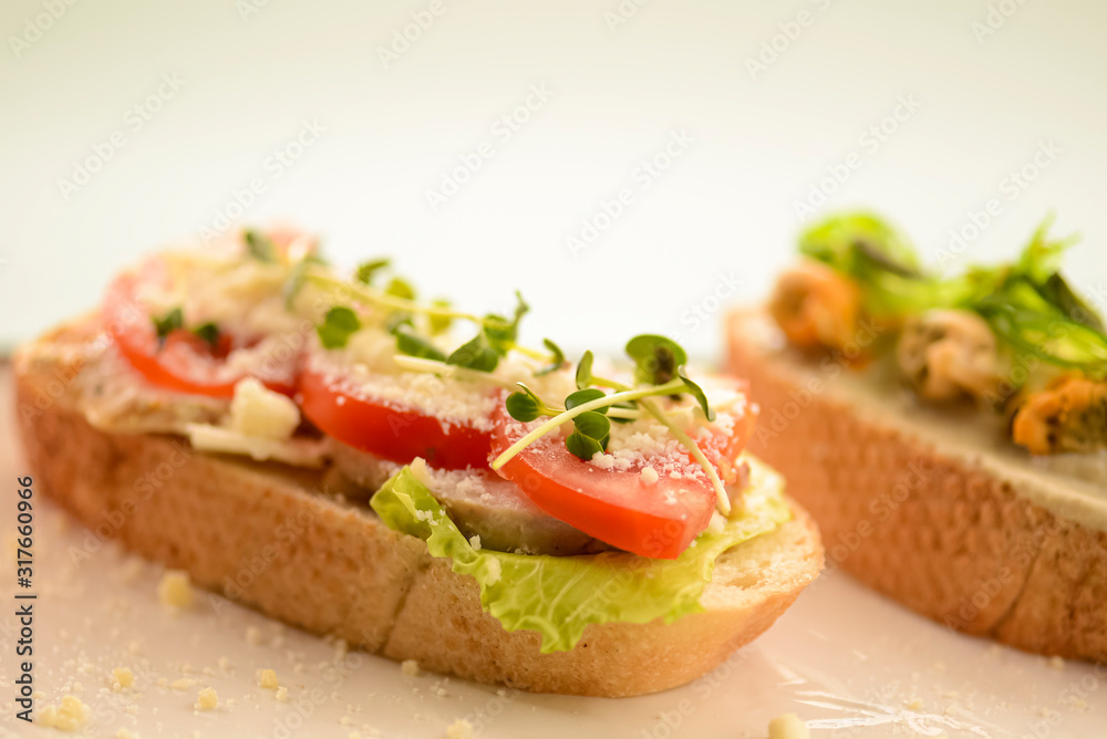 Traditional Italian bruschetta with parmesan cheese, tomato, prosciutto meat, mushrooms, seasoned with herbs