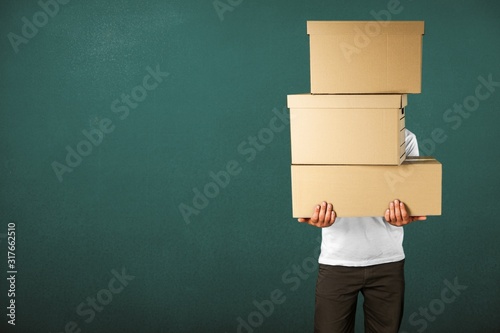 Man with cardboard boxes on background