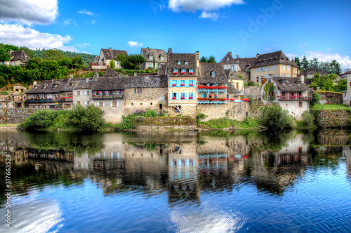Part of Argentat, France, Reflecting in the Calm Water photo