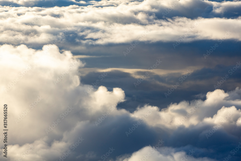 Aerial view of clouds seen from the plane window Aerial view of clouds seen from the plane window
