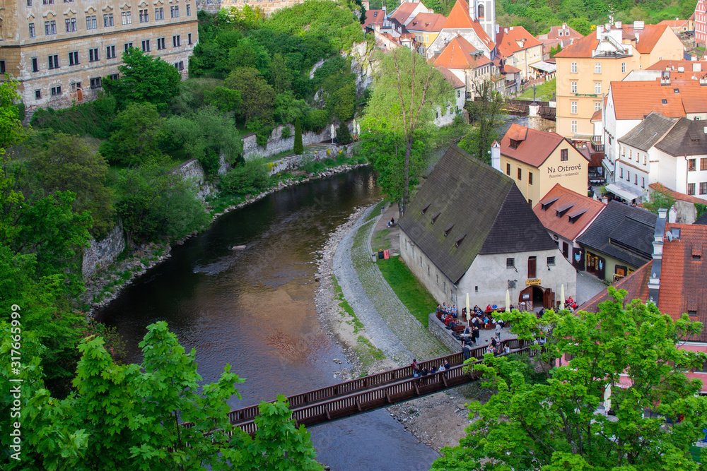 Aerial view of the traditional colorful houses of Cesky Krumlov and Vltava river with Lavka pod Zamkem (the bridge underneath the Castle), in Czech Republic