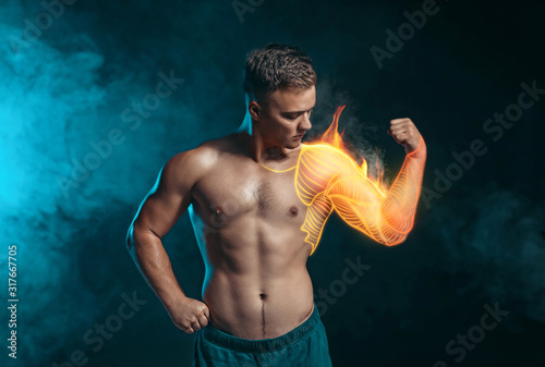 Handsome male bodybuilder on dark background