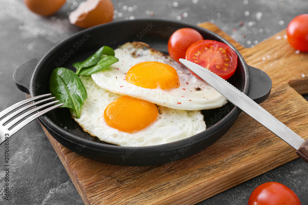 Frying pan with tasty eggs on table Frying pan with tasty eggs on table