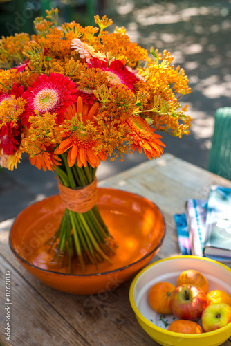 Wallpaper Mural Bouquet with orange and red Gerbera flowers  on a side table  Torontodigital.ca