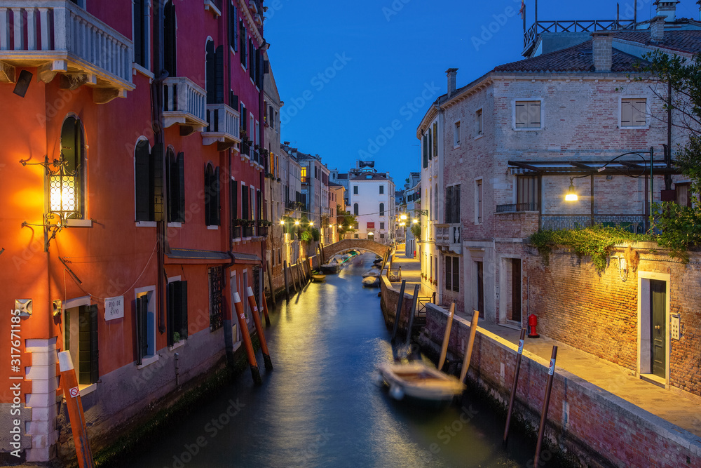 Beautiful photo of Venice at night. Light from the lanterns erupts in the canals of Venice