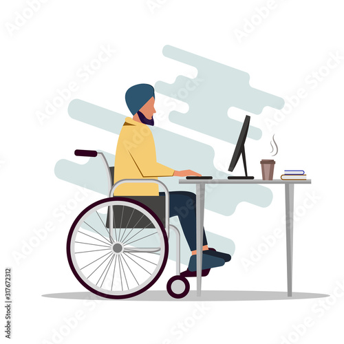 Indian man is sitting in a wheelchair and working at a computer. A disabled person works in an office.