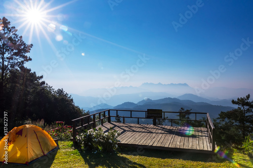 View of Doi Luang Chiang Dao, morning from sunrise with lens flare and camping tent form Doi Kham Fah Viewpoint, Padaeng National Park, Chiang Mai. photo