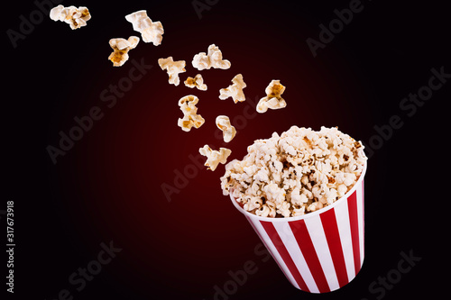 Popcorn flies from a bucket close-up, a place for text