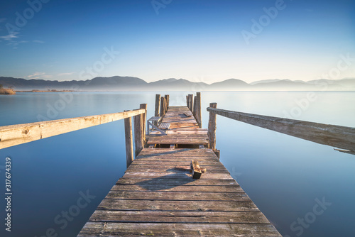 Wooden pier or jetty and lake at sunrise. Torre del lago Puccini Versilia Tuscany  Italy
