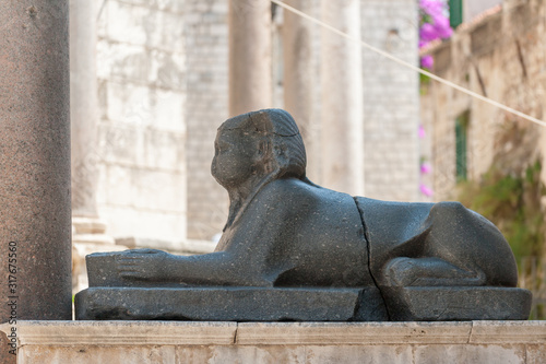 Close up of black granite Egyptian sphinx sitting on Peristyle, central square of the Diocletian palace in Split, Croatia