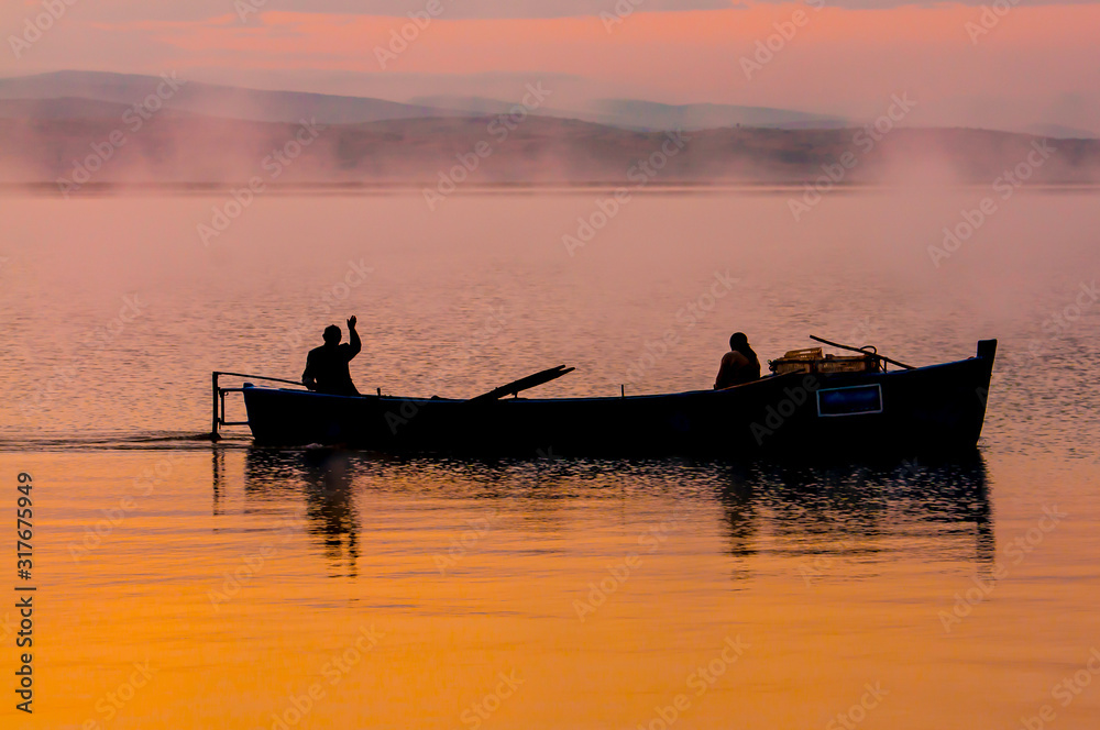 people who start the day with fishing and magnificent sunrise views on the lake