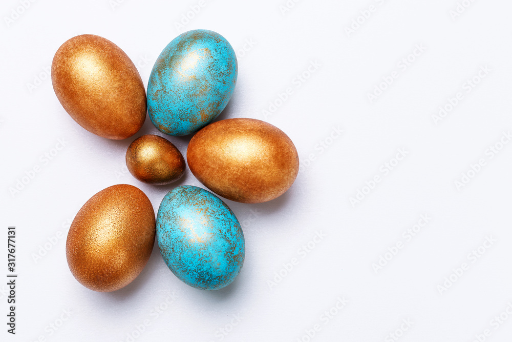 Blue and golden modern easter eggs on a white background. View from above. Isolated. Like the shape of a flower.