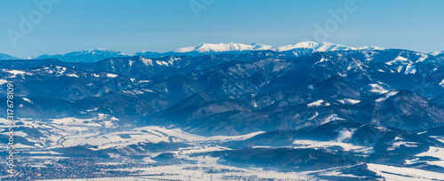 Velka Fatra and highest Nizke Tatry mountains on the background from sedlo Okopy bellow Mincol hill in winter Mala Fatra mountains in Slovakia