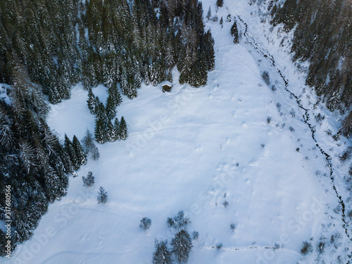 Aerial view of snow covered winter landscape in rural mountain region.