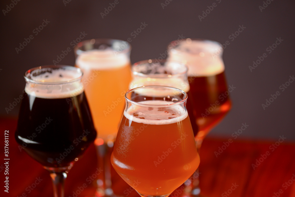 Three glasses with different beer on wooden table in a bar. Food photography concept, with copy space Three glasses with different beer on wooden table in a bar. Food photography concept, with copy space