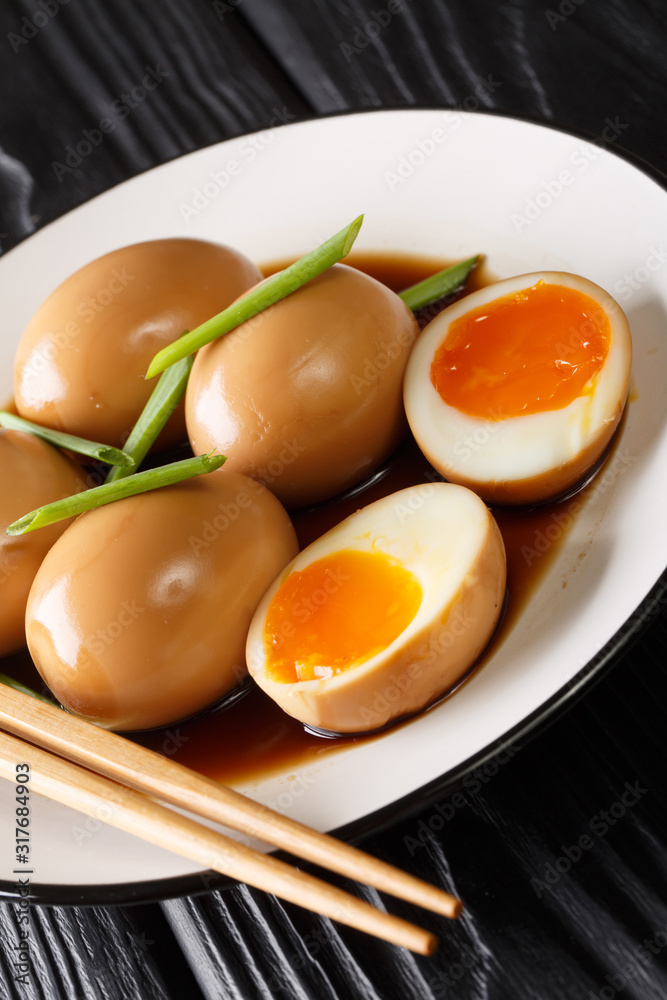Recipe of delicious japanese nitamago eggs close-up in a plate. vertical Recipe of delicious japanese nitamago eggs close-up in a plate. vertical