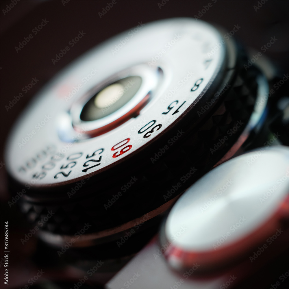 Analog film camera top view with a shutter dial set to aperture