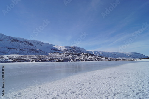 winter landscape with snow covered mountains and a frozen sea in Iceland