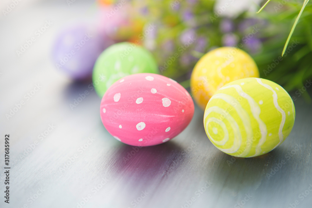 Painted easter decoration with and flowers on gray wooden table. Painted easter decoration with and flowers on gray wooden table.