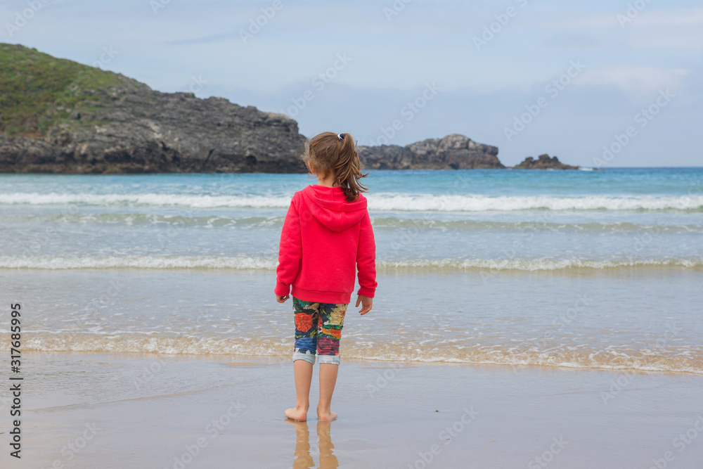 girl playing at the beach