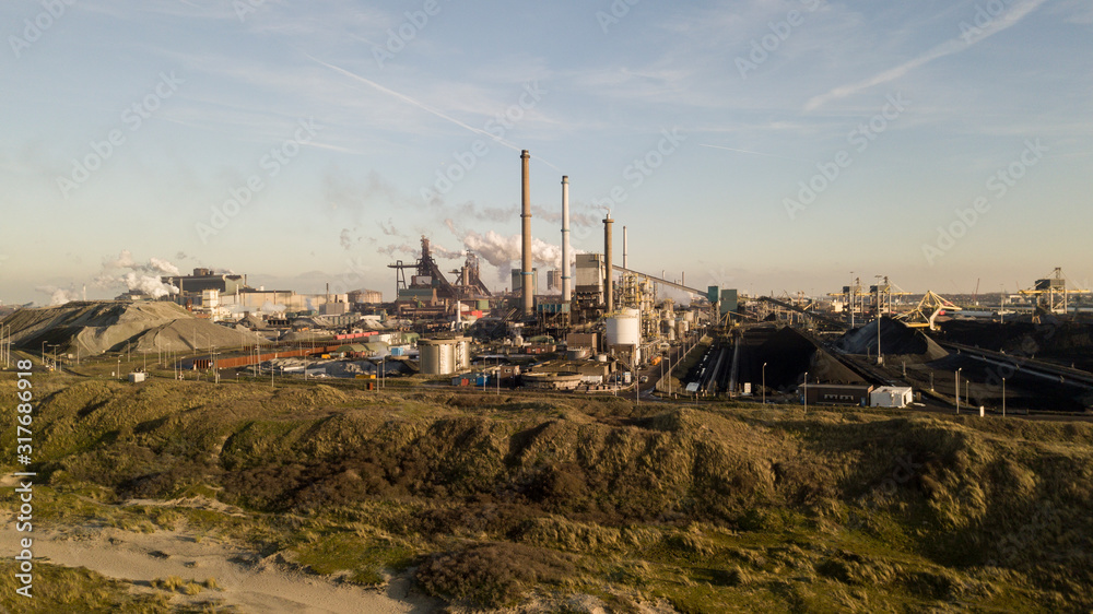 Factory Tata Steel with smoking chimneys on a sunny day, IJmuiden, The Netherlands
