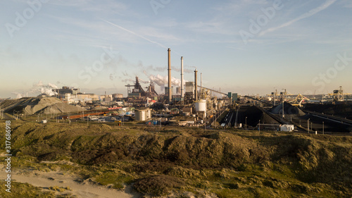 Factory Tata Steel with smoking chimneys on a sunny day, IJmuiden, The Netherlands