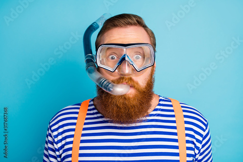 Close up photo of funky shocked red hair man watersport lover breathe diving tube have mask wear nautical vest orange suspenders isolated over blue color background photo