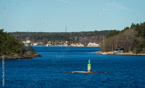 Picturesque summer houses painted in traditional falun red on dwellings island of the Stockholm archipelago in the Baltic Sea in the early morning. photo