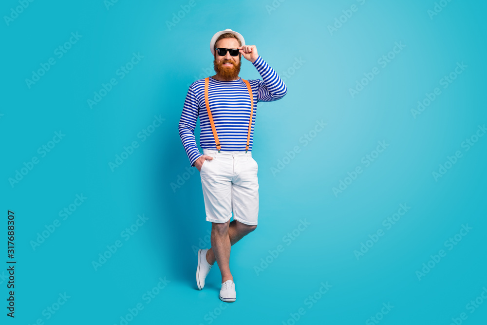 Full body photo of cheerful attractive man enjoy summer rest journey touch modern specs wear good look nautical vest isolated over blue color background Full body photo of cheerful attractive man enjoy summer rest journey touch modern specs wear good look nautical vest isolated over blue color background
