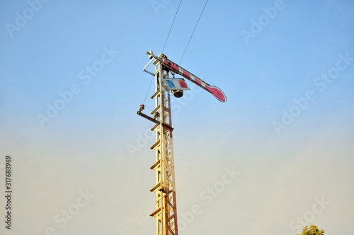 Photos of railway sign stands on a railway signal pole.