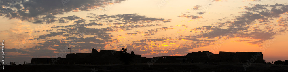Silhouette of Ancient Bahrain Fort during sunset, Bahrain. A panoramic view