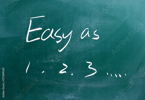 Easy as 1 2 3 phrase written on a chalkboard