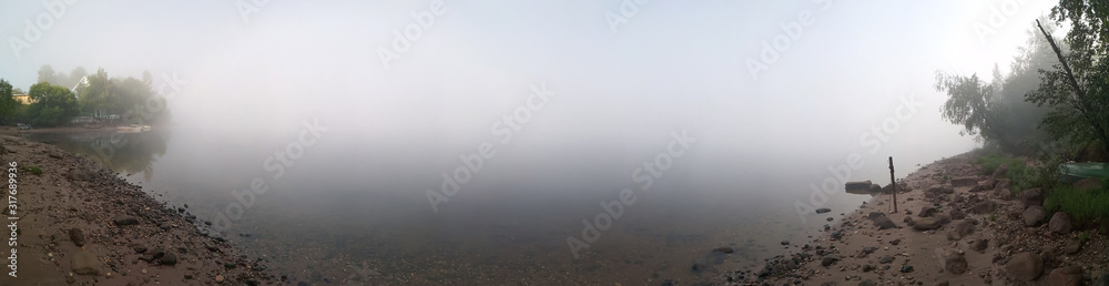Fototapeta premium Panorama of the river in the morning with fog boats sandy shore